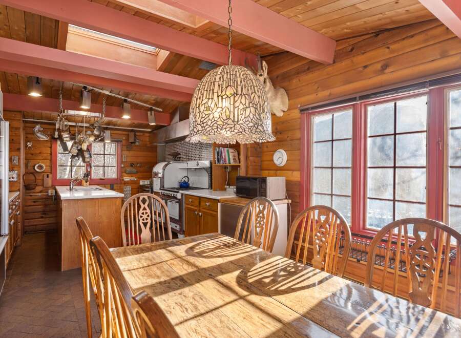 This charming dining room features a rustic wooden table and chairs, perfect for family gatherings.