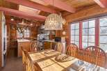 This charming dining room features a rustic wooden table and chairs, perfect for family gatherings.