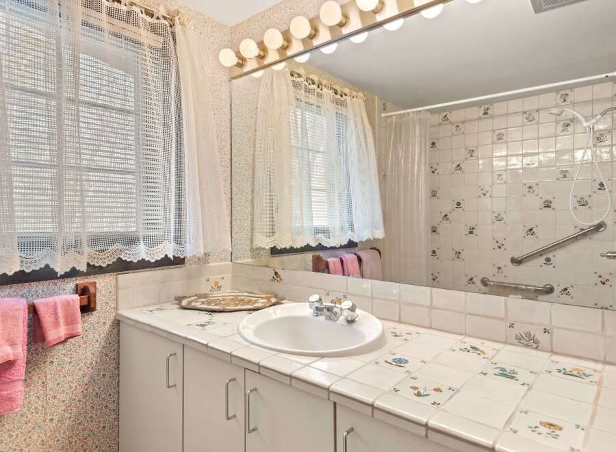 This charming bathroom features a classic design with a touch of vintage flair.