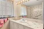 This charming bathroom features a classic design with a touch of vintage flair.