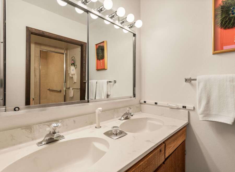 This bathroom features a double vanity with ample counter space, perfect for getting ready in the morning.