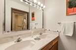This bathroom features a double vanity with ample counter space, perfect for getting ready in the morning.