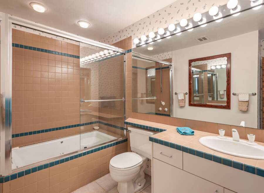 This bathroom features a classic design with a combination of functionality and style.
