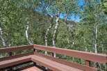 Enjoy the serene mountain views from this charming deck, perfect for relaxing amidst nature.