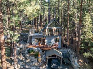 Nestled in a serene forest setting, this charming cabin offers a perfect blend of rustic charm and modern comfort.