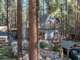 Nestled in a serene forest setting, this charming property offers a unique blend of rustic charm and modern comfort.