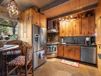 Step into rustic elegance with this stunning kitchen! Featuring custom wood cabinetry, stainless steel appliances, and a unique stone backsplash, this space is perfect for both cooking and entertaining.