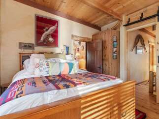 Step into a cozy bedroom retreat, where rustic charm meets modern comfort.