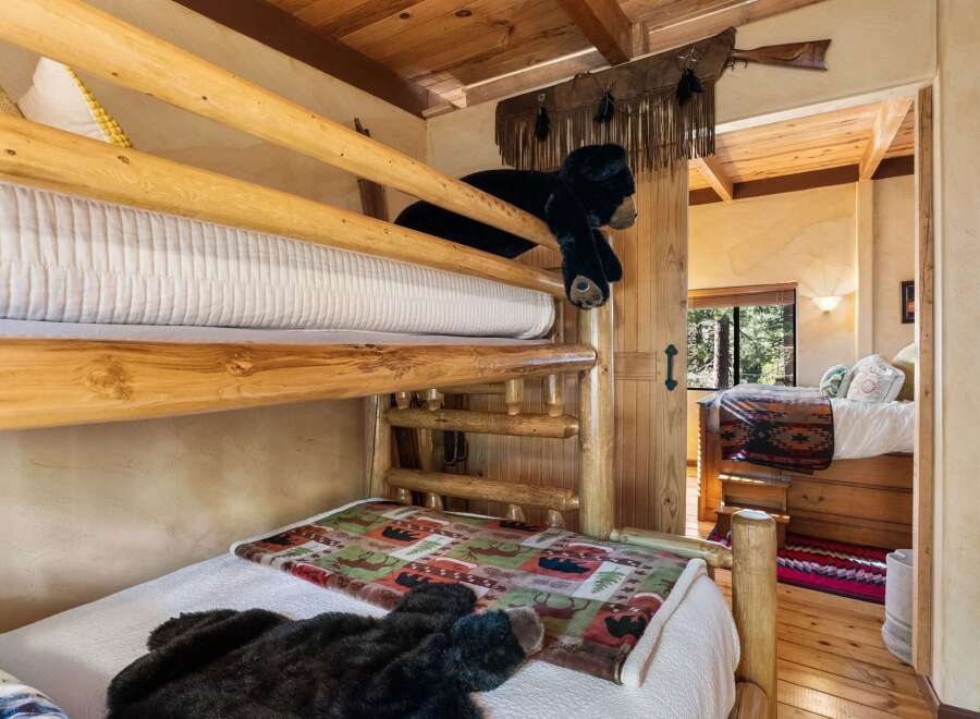 This charming cabin bedroom features a rustic bunk bed, perfect for a cozy getaway.