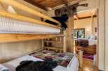 This charming cabin bedroom features a rustic bunk bed, perfect for a cozy getaway.
