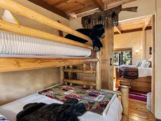 This charming cabin bedroom features a rustic bunk bed, perfect for a cozy getaway.