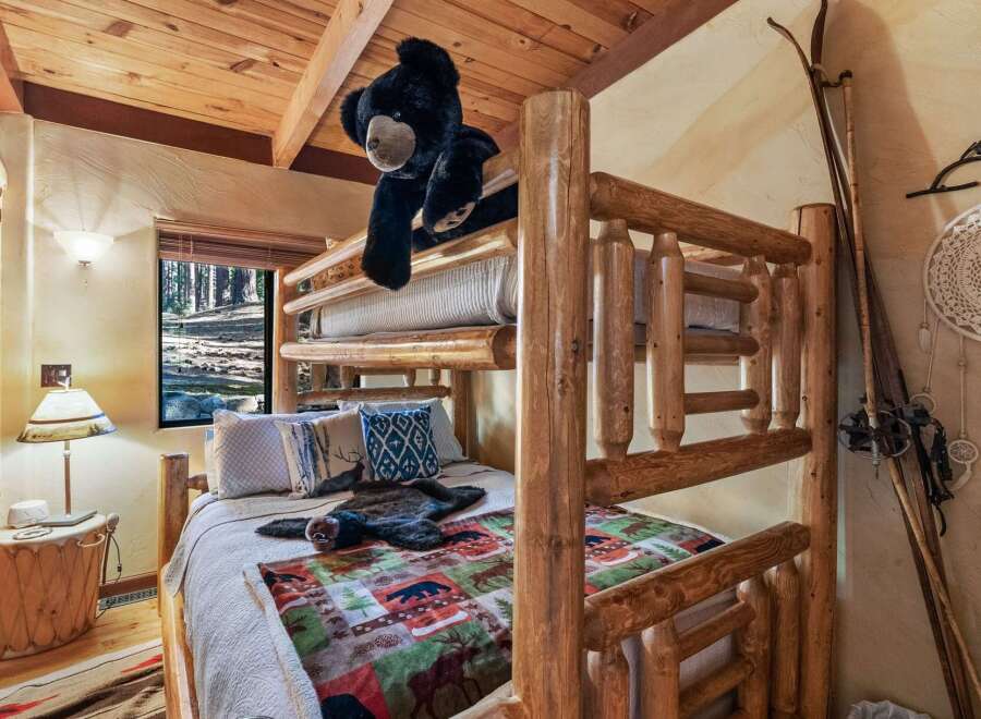 This cozy cabin bedroom features a rustic bunk bed, perfect for a family getaway.