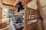 This cozy cabin bedroom features a rustic bunk bed, perfect for a family getaway.