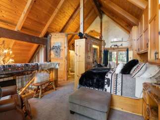 Step into rustic luxury with this stunning cabin bedroom.