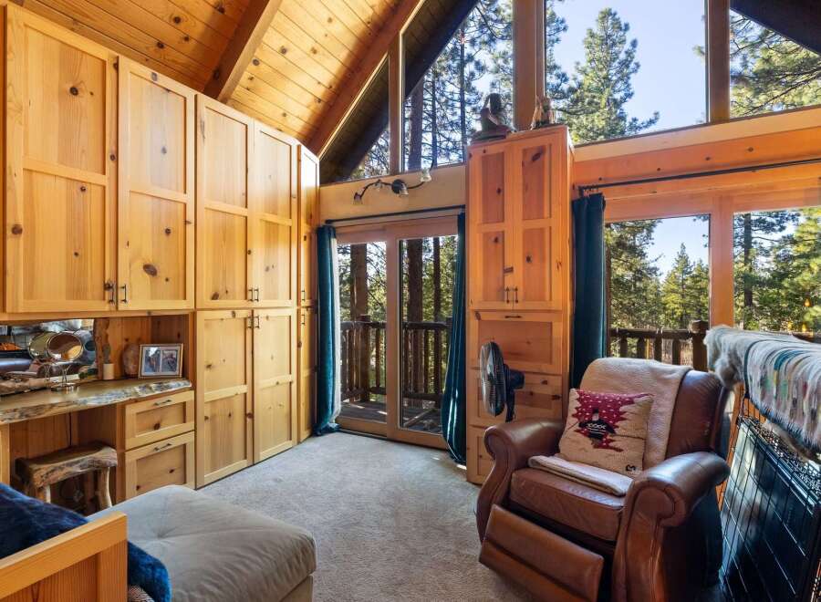 Step into a cozy retreat with this stunning property, featuring a beautifully crafted interior with natural wood finishes.