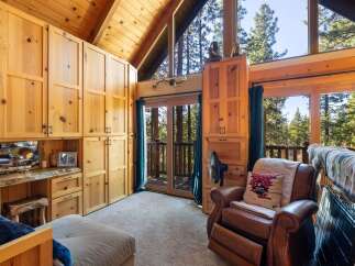 Step into a cozy retreat with this stunning property, featuring a beautifully crafted interior with natural wood finishes.