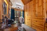 Step into this charming cabin office, featuring a cozy workspace with a view.