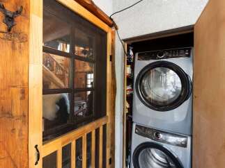 Step into rustic charm with this unique property! Featuring a cozy interior with a stacked washer and dryer, this home offers convenience and style.