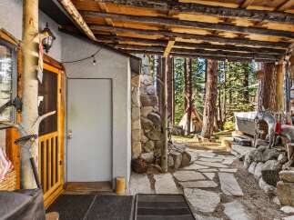 Escape to your own private oasis with this charming cabin nestled in the woods.