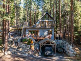 Nestled in a serene forest setting, this charming cabin offers a perfect blend of rustic charm and modern comfort.