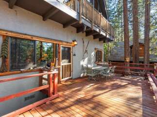 Enjoy the tranquility of this charming cabin with a spacious deck, perfect for outdoor gatherings.
