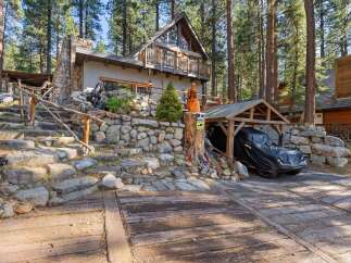 Nestled in a serene, wooded setting, this charming property offers a unique blend of rustic elegance and modern comfort.