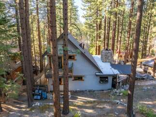 Nestled in a serene forest setting, this charming property offers a unique blend of rustic charm and modern comfort.