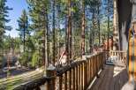 Enjoy the tranquility of nature from this stunning property! This home features a beautiful wooden deck that overlooks a lush forest of tall trees.