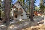 Nestled amidst towering trees, this charming A-frame cabin offers a serene escape.