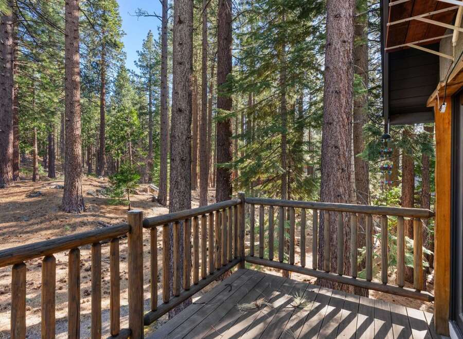 Escape to nature's embrace with this stunning property, offering a serene retreat surrounded by towering trees.