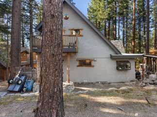 Nestled in a serene wooded setting, this charming property offers a unique blend of rustic charm and modern comfort.