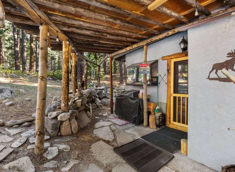 Discover the charm of this rustic cabin, nestled in a serene wooded setting.