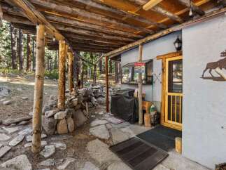 Discover the charm of this rustic cabin, nestled in a serene wooded setting.