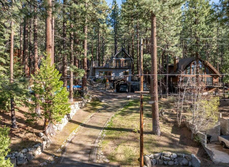 Nestled amidst towering trees, this stunning property offers a serene escape.