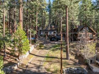 Nestled amidst towering trees, this stunning property offers a serene escape.