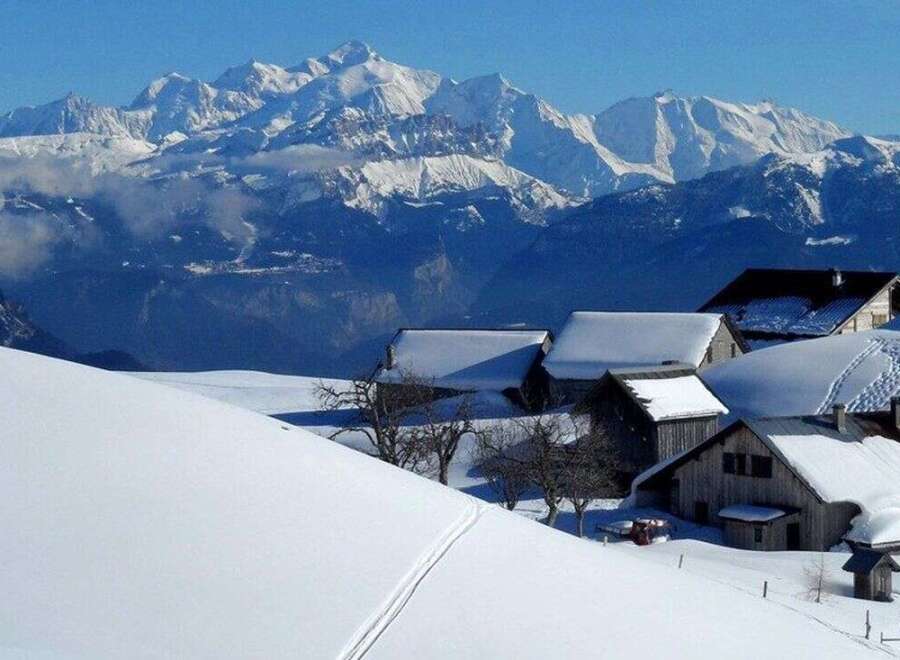 Discover your dream alpine retreat! This stunning property boasts breathtaking mountain views and charming, snow-covered chalets.