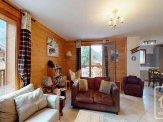 Discover the charm of this cozy living space, featuring warm wooden accents and a welcoming atmosphere.