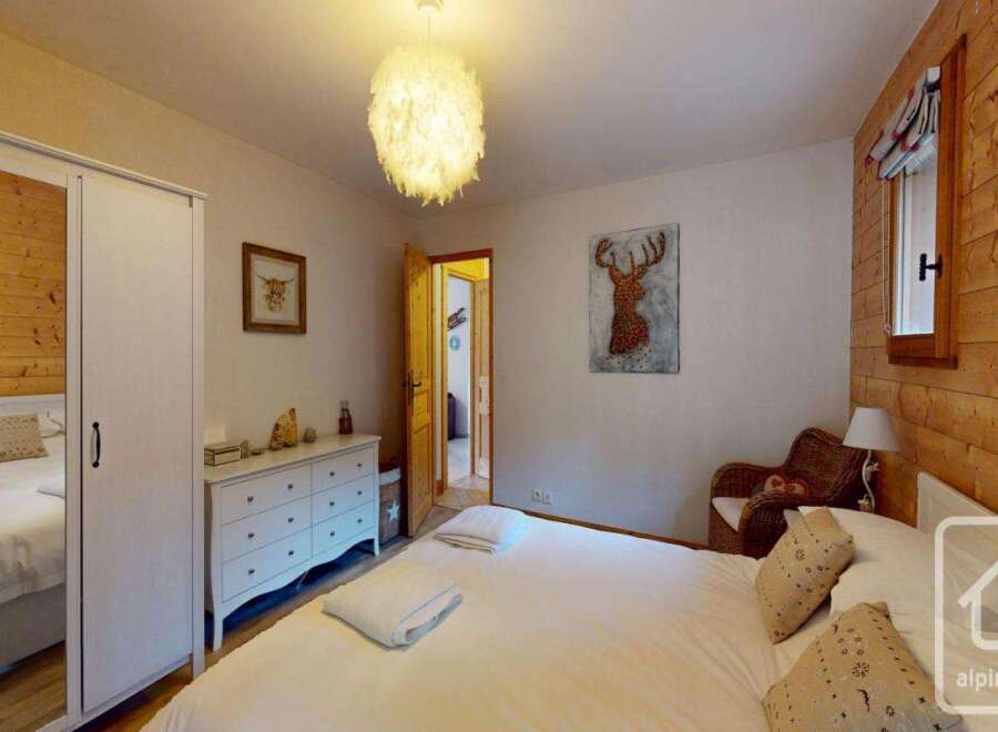 Discover the charm of this inviting bedroom, featuring a cozy bed and ample natural light.
