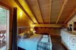 This charming bedroom features a cozy wooden interior, creating a warm and inviting atmosphere.
