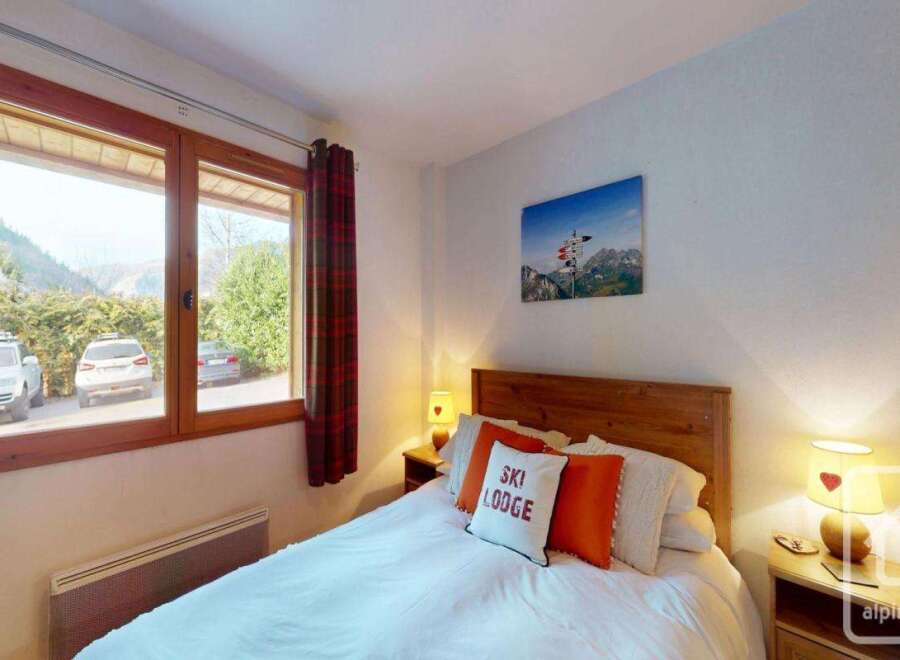 This cozy bedroom offers a comfortable retreat with a charming ambiance.