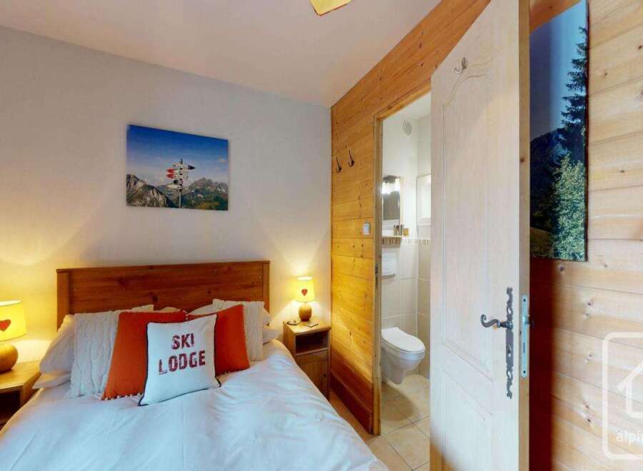 Discover the charm of this cozy ski lodge bedroom, perfect for a mountain getaway.