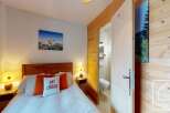Discover the charm of this cozy ski lodge bedroom, perfect for a mountain getaway.