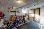 This spacious garage offers ample storage space for vehicles, tools, and equipment.