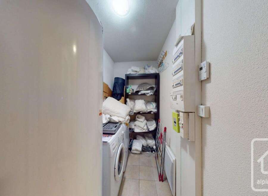 Discover the potential of this versatile space! This image showcases a functional utility room, perfect for laundry and storage.