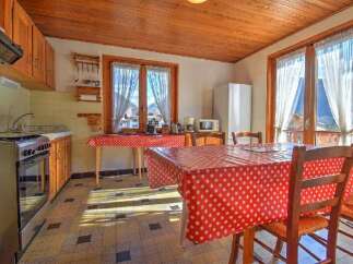 Charming kitchen with a rustic touch, featuring wooden cabinets and a cozy dining area.