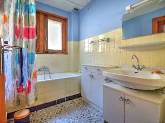This charming bathroom features a classic design with a touch of vintage flair.