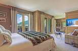 Experience luxury living in this stunning property, featuring a spacious bedroom with breathtaking mountain views.