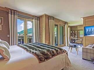 Experience luxury living in this stunning property, featuring a spacious bedroom with breathtaking mountain views.