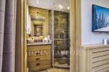 Step into luxury with this stunning bathroom featuring a sleek shower and a modern vanity.