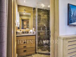 Step into luxury with this stunning bathroom featuring a sleek shower and a modern vanity.